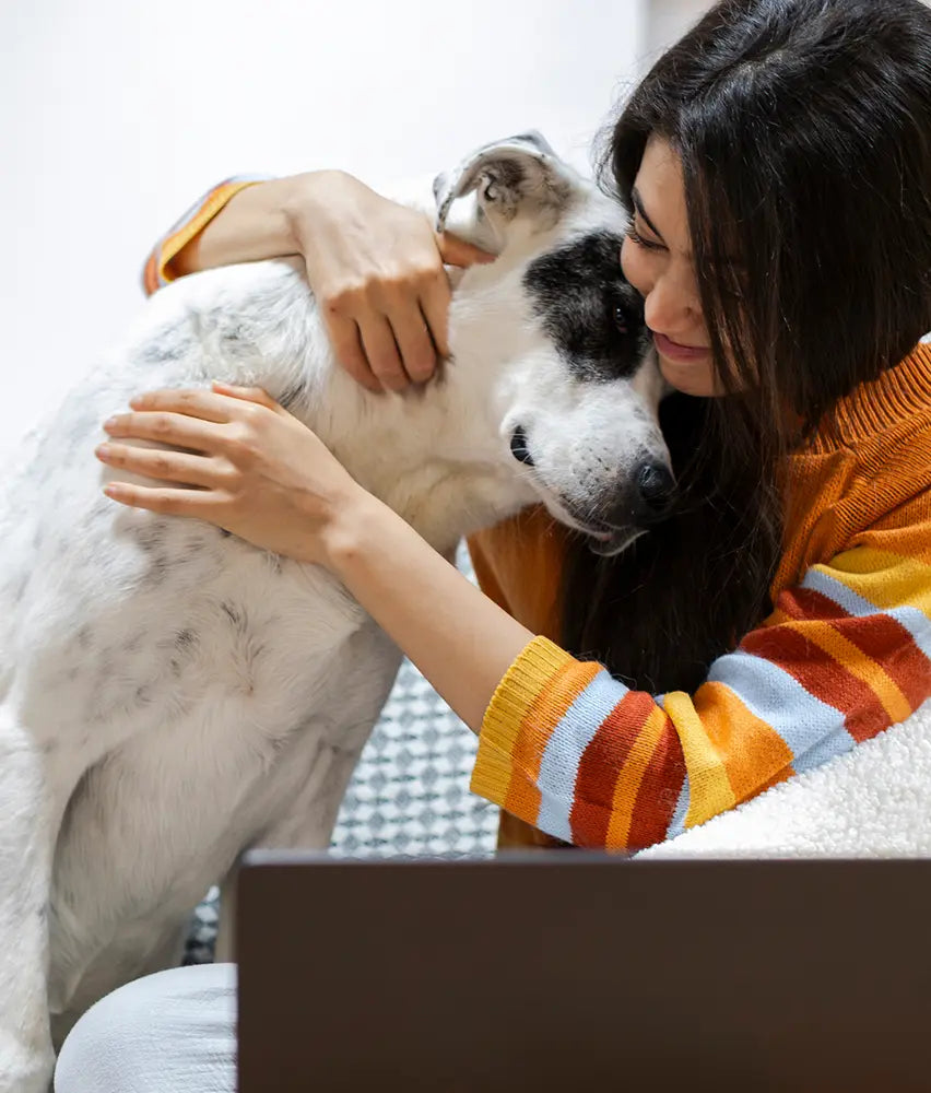 Pet owner hugging her dog while reviewing the diagnosis